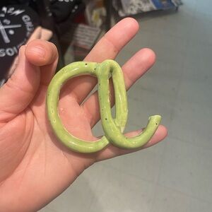 green ceramic letter A wall hanging